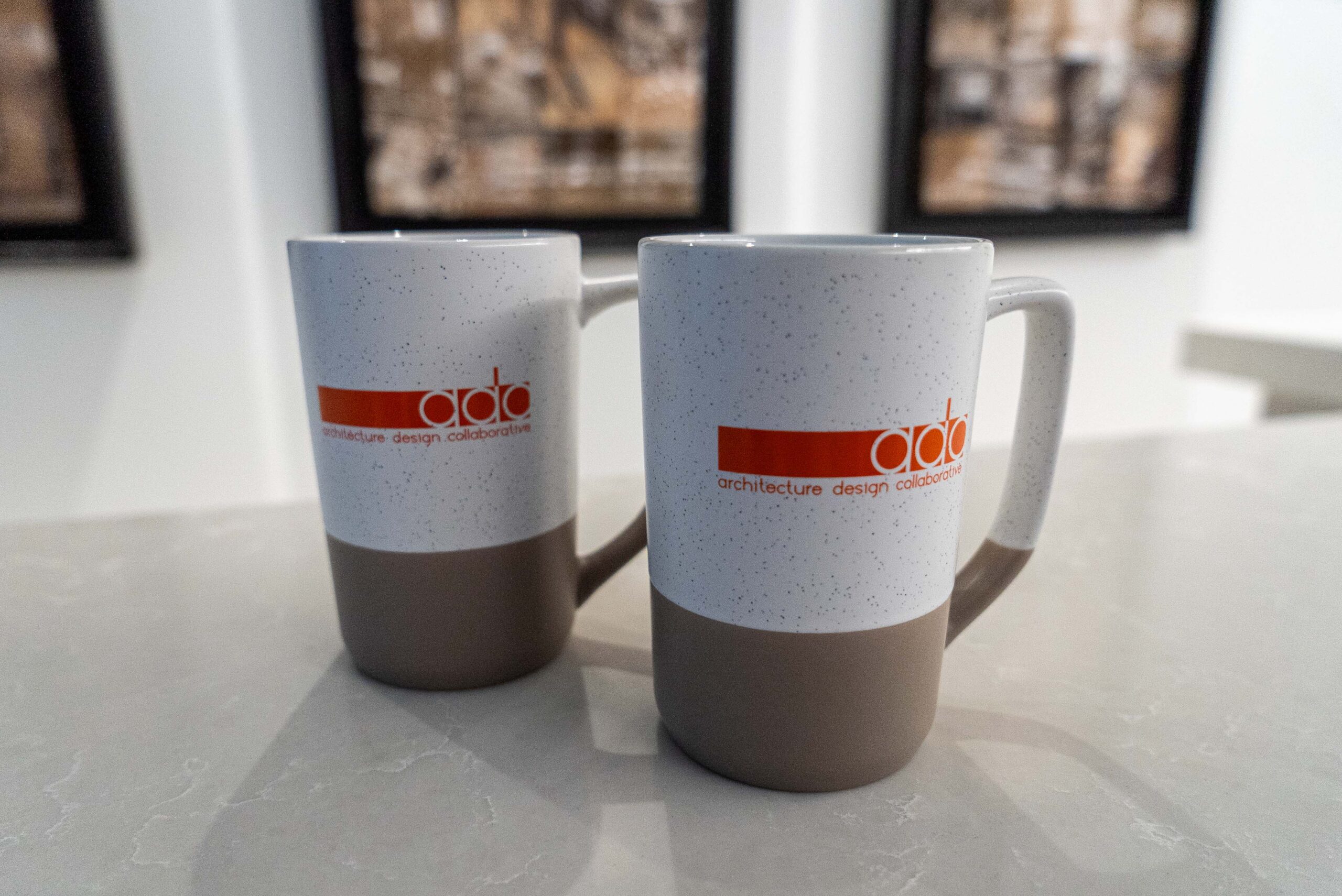 An image of branded mugs at the Architecture Design Collaborative (ADC) office.