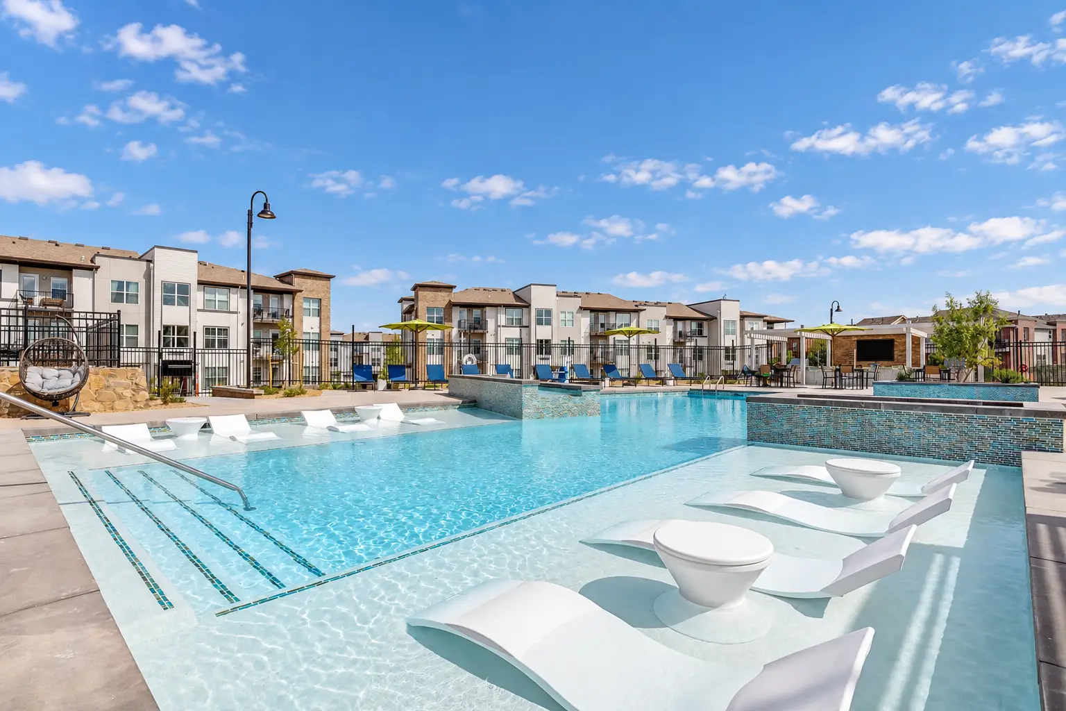 I would use the strongest overall exterior rendering that shows multiple residential buildings and gives a sense of the full community rather than leading with the clubhouse.