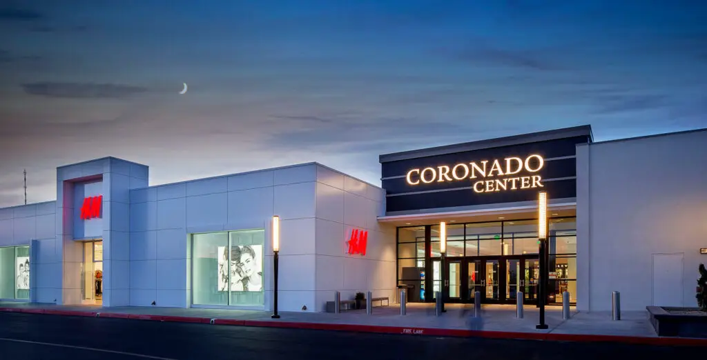Coronado Center and H&M entrance at dusk with illuminated signage