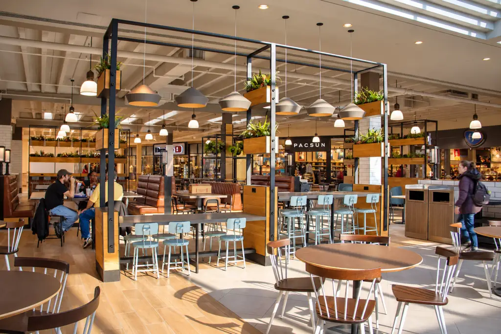 Renovated food hall at Mall St. Matthews in Louisville, Kentucky, featuring new seating, finishes, and gathering areas designed by Architecture Design Collaborative.
