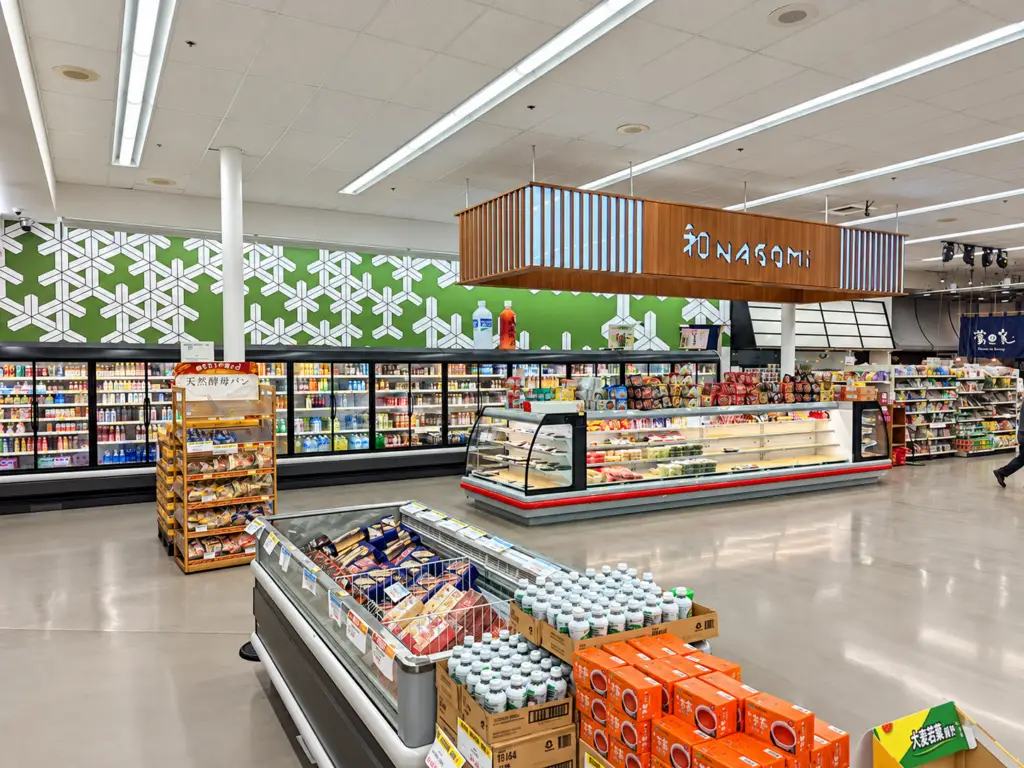 Grocery floor at Mitsuwa Marketplace Costa Mesa with new refrigerated cases, a wood Nagomi canopy, and green patterned wall graphics