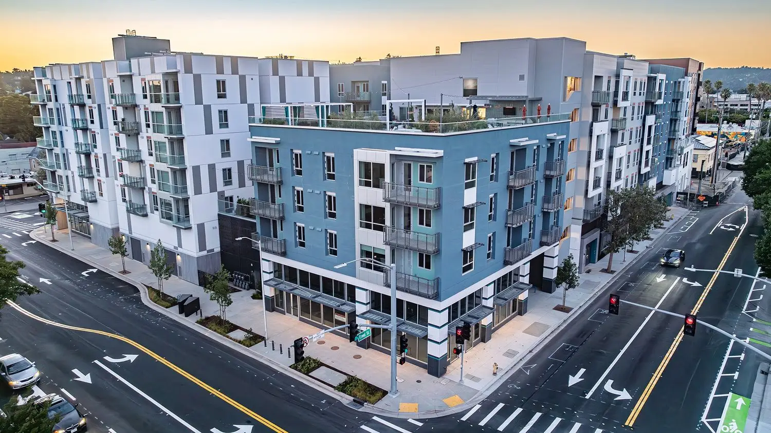 Anton Pacific multifamily community in Santa Cruz with contemporary architecture, rooftop amenities, and street-level frontage at sunset