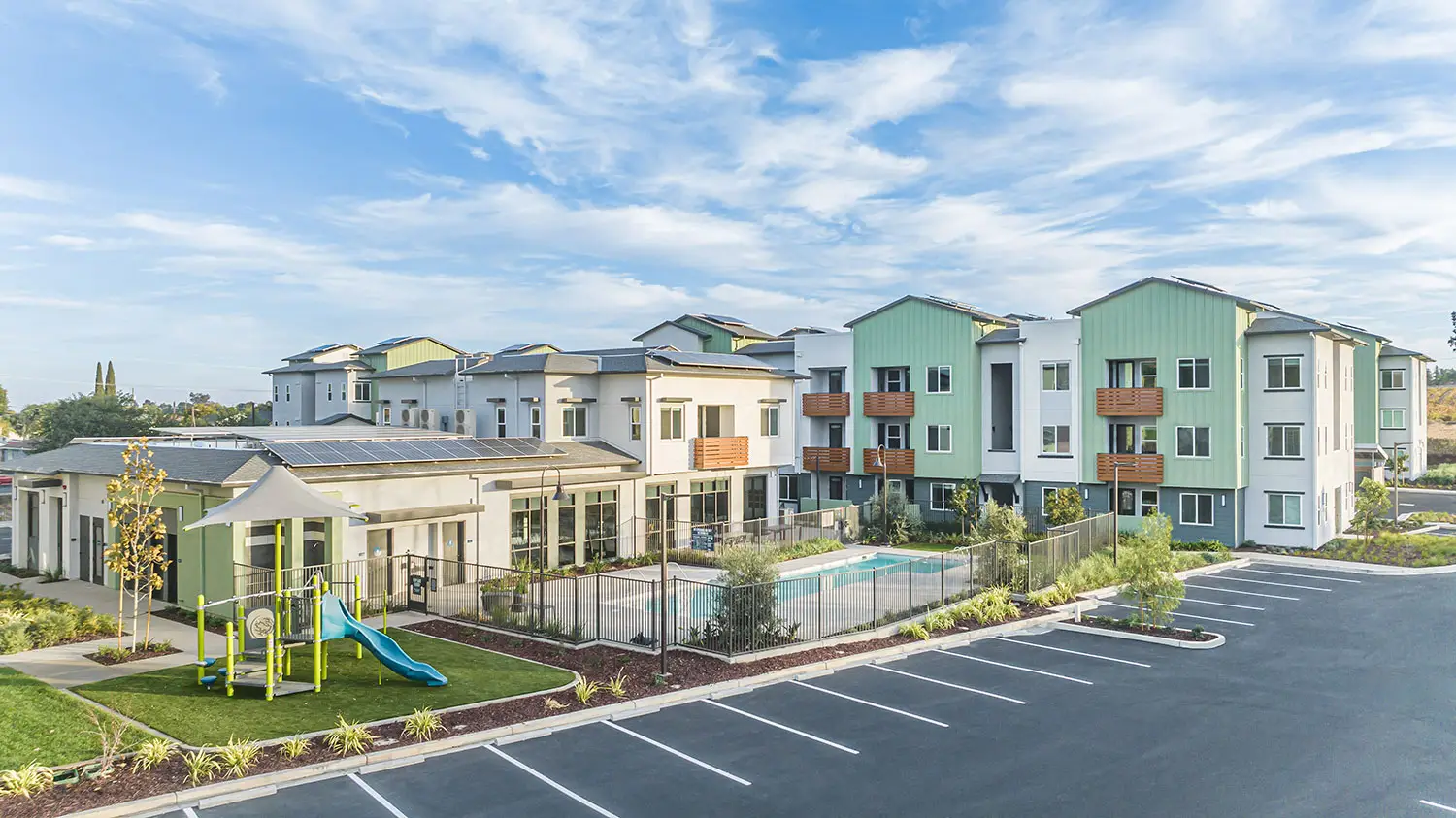 Anton Viridian affordable housing community in Oakley with contemporary three-story apartments, pool, playground, and landscaped outdoor amenities