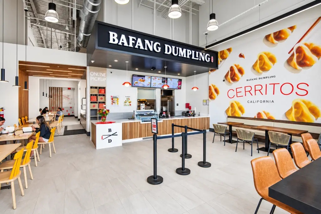 Bafang Cypress restaurant interior with wood-slat portal and illuminated branding