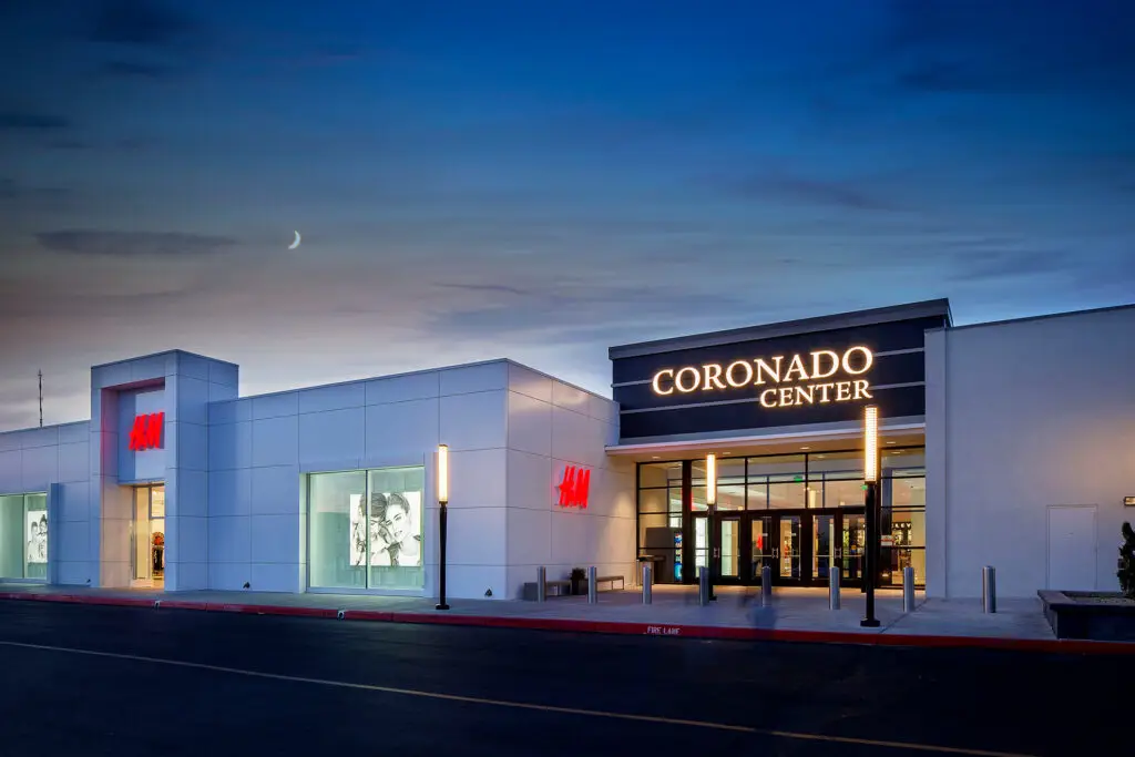 Night exterior of H&M and the Coronado Center entrance in Albuquerque, designed by Architecture Design Collaborative
