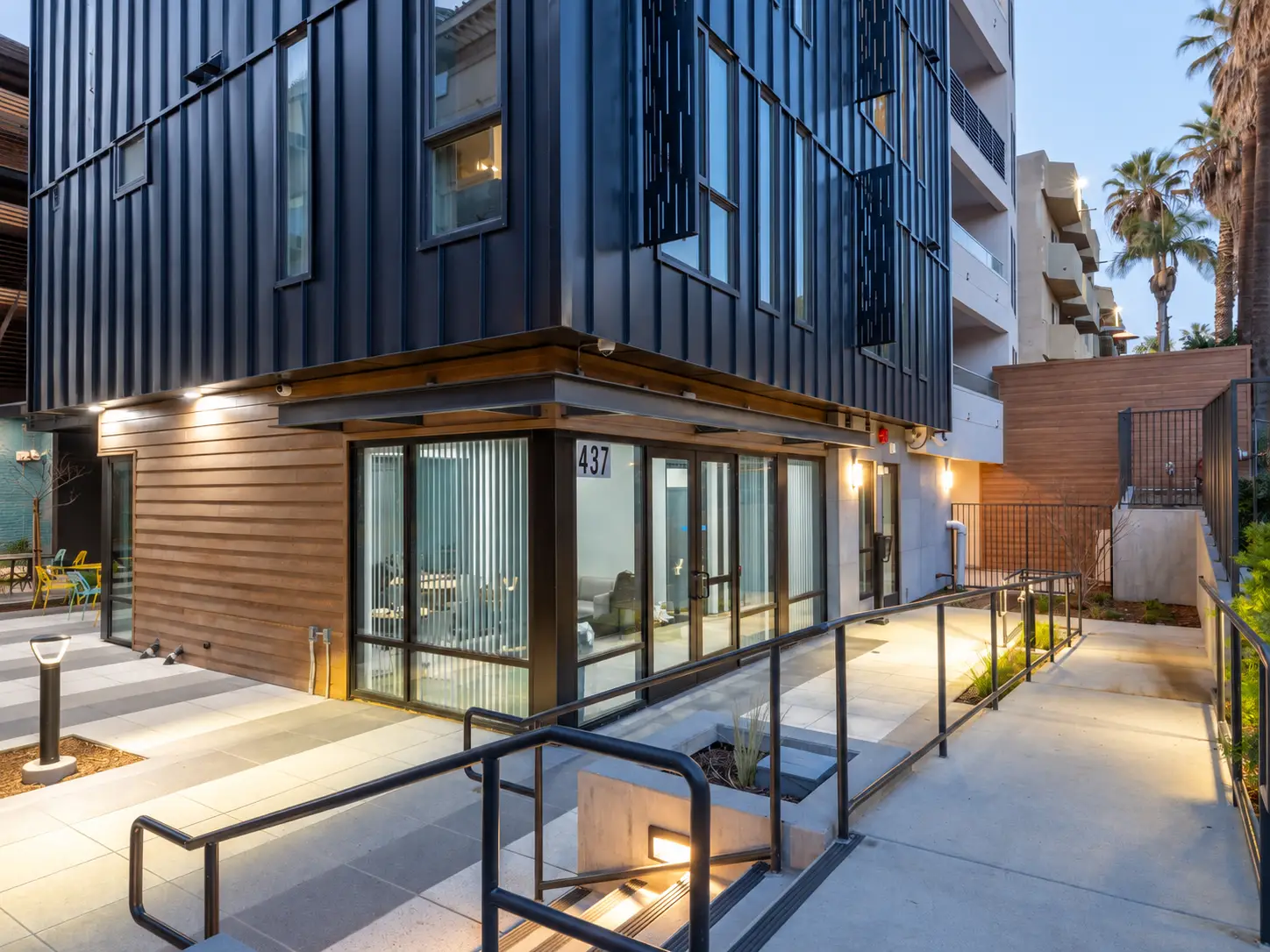 Street view of The Lake House in Los Angeles, with a dark metal-clad volume, white wing, and address 437