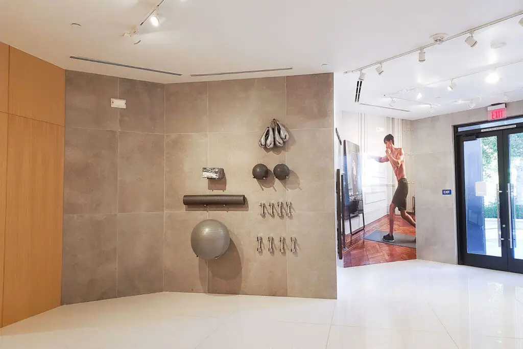 MIRROR connected-fitness showroom at Stanford Shopping Center in Palo Alto, with a tiled equipment wall, large digital display, and glass entry