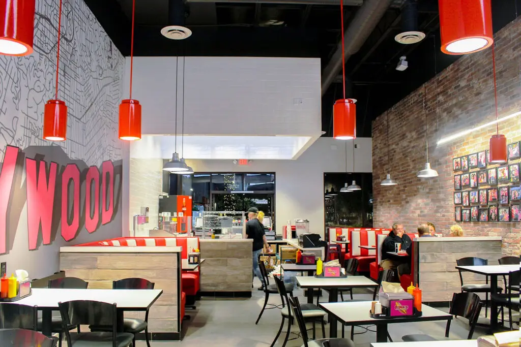 Pink’s Hot Dogs interior at Camarillo Premium Outlets featuring custom booths and Hollywood-inspired details designed by Architecture Design Collaborative