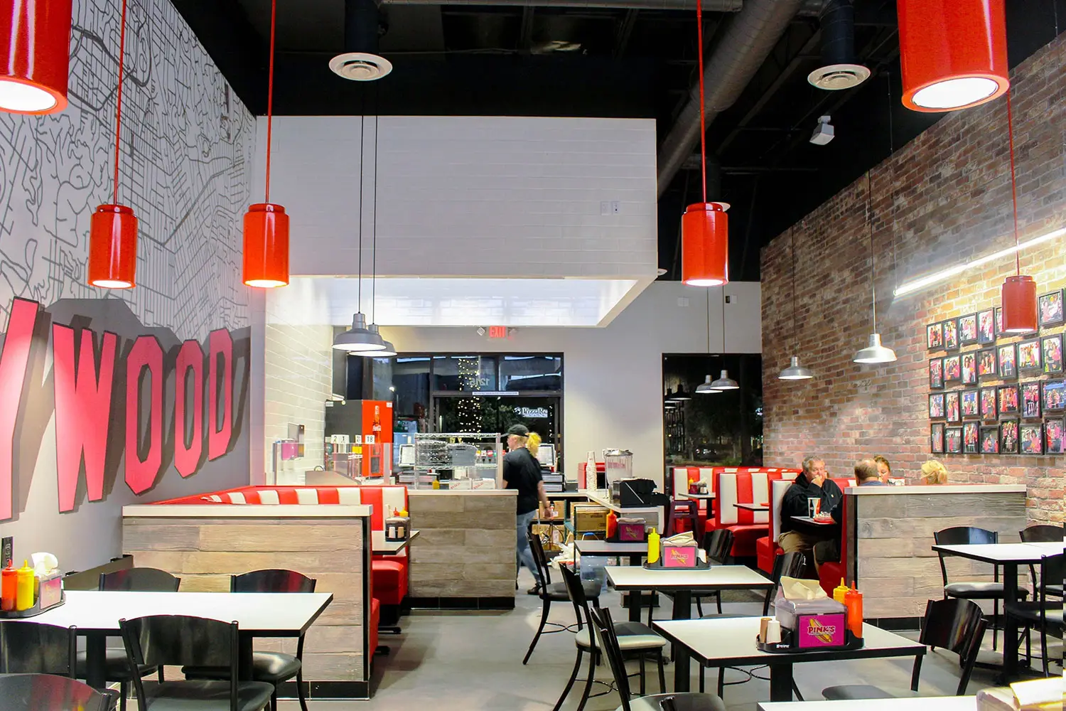 Pink’s Hot Dogs interior at Camarillo Premium Outlets featuring custom booths and Hollywood-inspired details designed by Architecture Design Collaborative