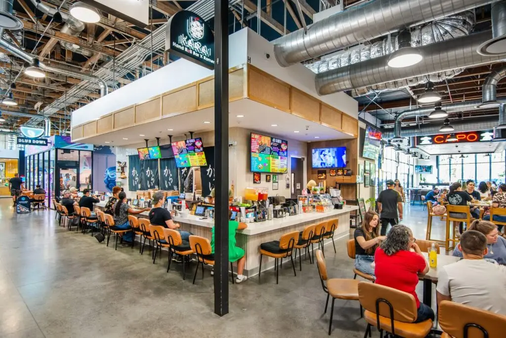 RKarai hand-roll and ramen bar at Rodeo 72 with counter seating and the Capo sign beyond
