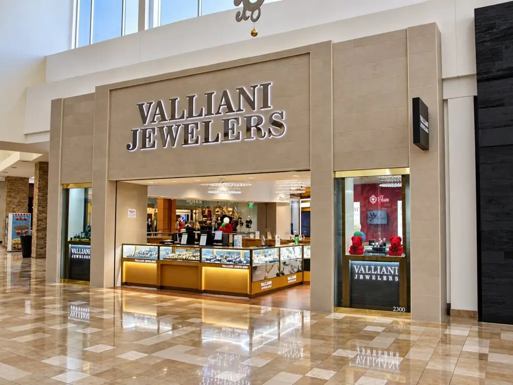 Valliani Jewelers Chandler open storefront at space 2300 with halo-lit signage and a wood jewelry case facing the mall.