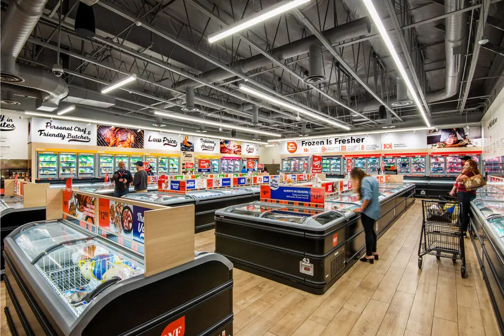 Sales floor at Wild Fork Mission Viejo with island freezers, wall cases, and Frozen Is Fresher graphics