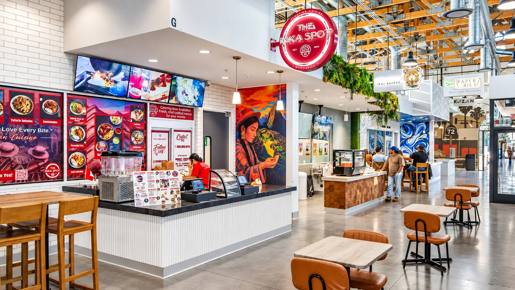 Rodeo 72 food hall in Whittier, California, featuring restaurant storefronts, colorful murals, and communal dining space
